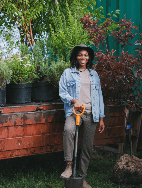 A woman holding shovel in the garden